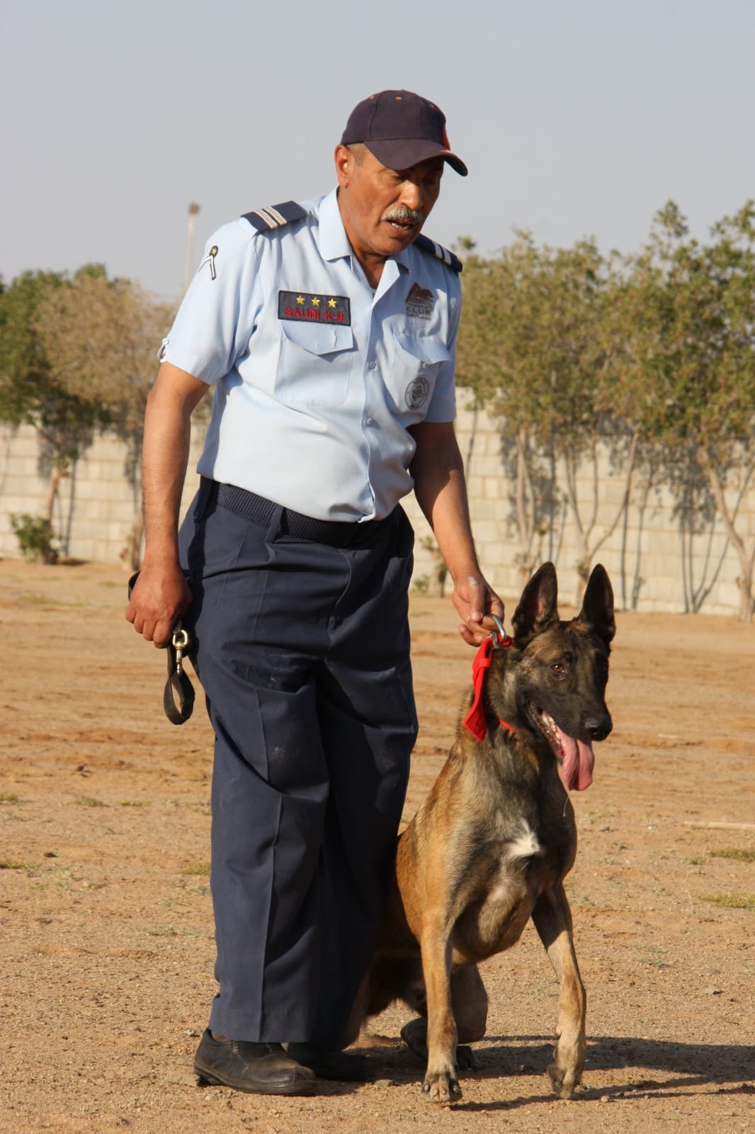 Official Saudi K-9 trainer in uniform with Arabian Kennels Club emblem